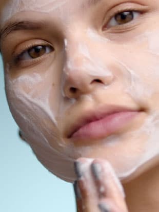 Model rubbing Lathering Tube Soap on face